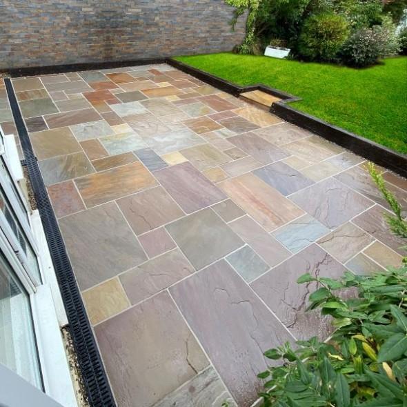 Multi-tone sandstone courtyard with dark retaining borders