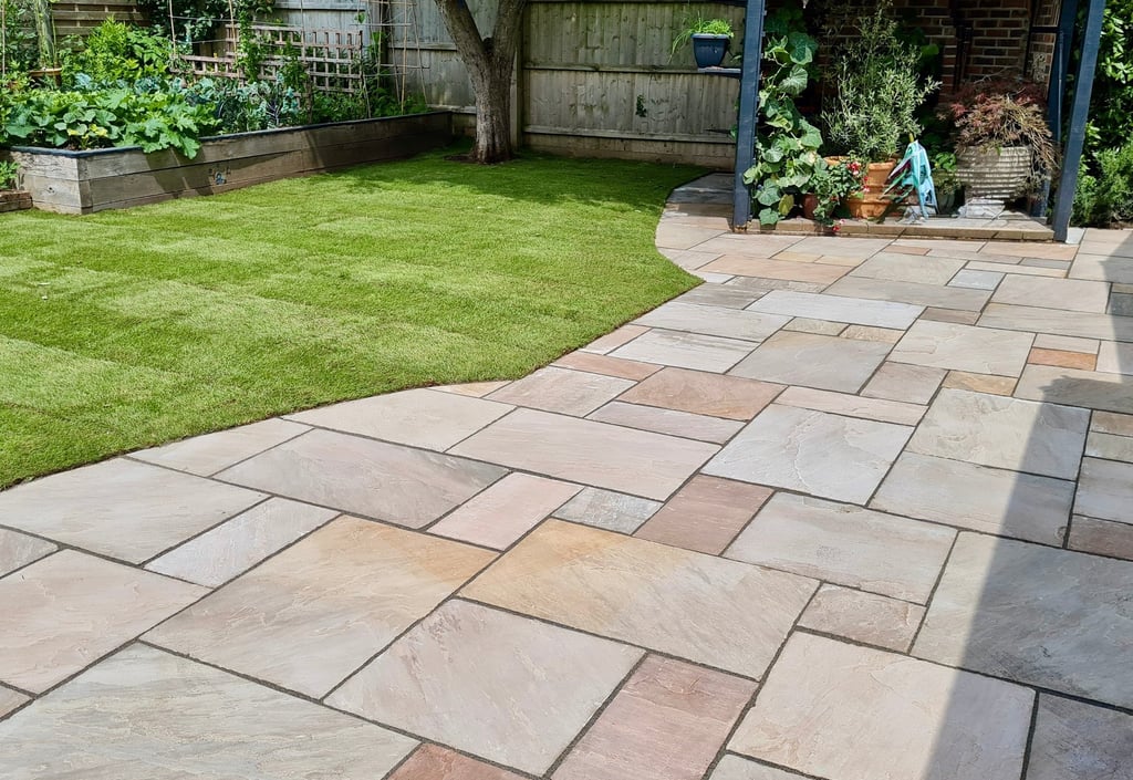 Fresh lawn laid beside a natural sandstone patio