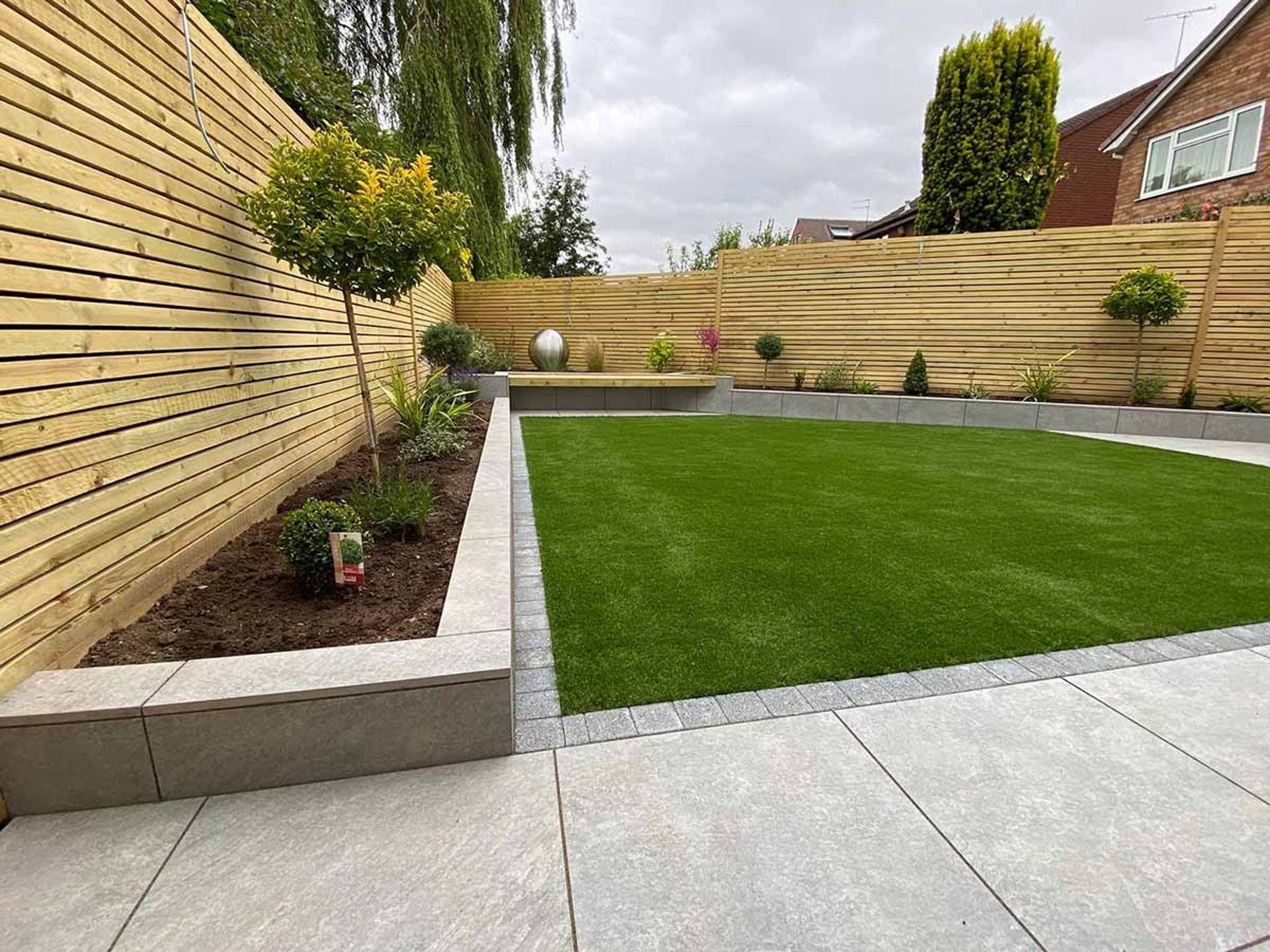 Contemporary timber fencing around a landscaped lawn